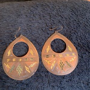 Bronze color earrings with gold color inlays.